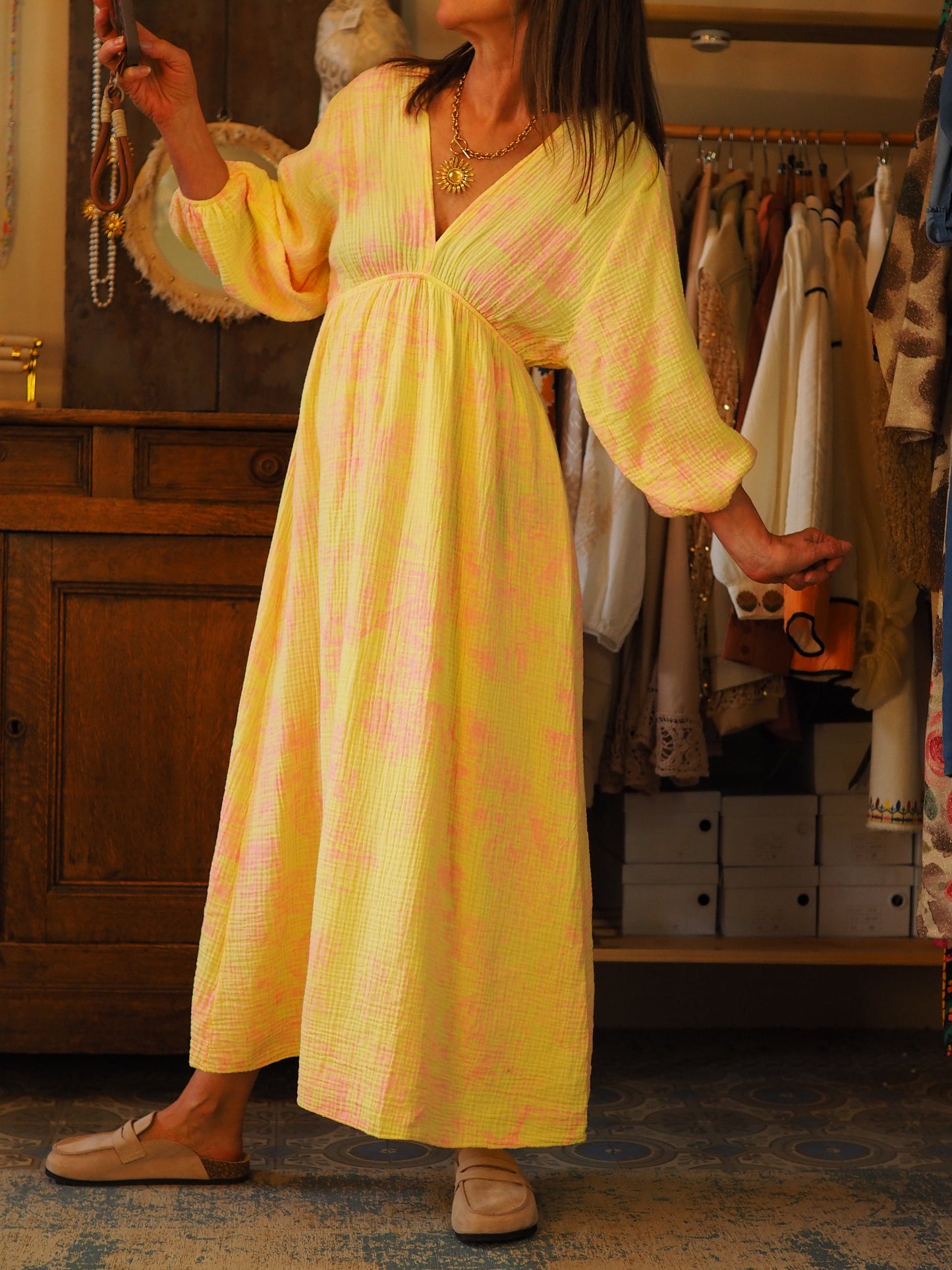 Robe en gaz de coton jaune. Motifs paysages roses. Manches 3/4 élastiques. Col V devant et dans le dos. Taille élastique.
100% Coton.
Taille unique convient du 36 au 40/42.