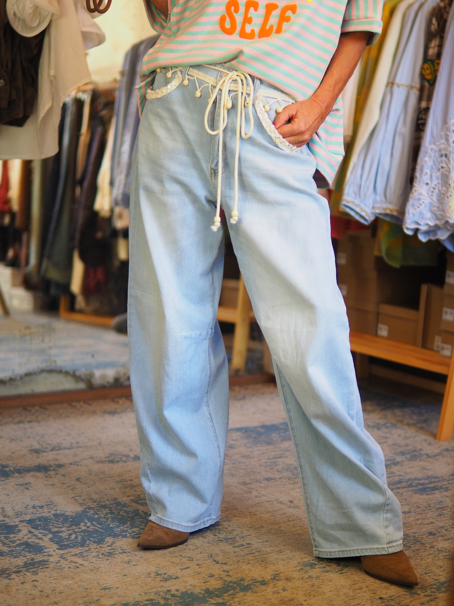 Jean large en denim clair avec taille à cordons et détails fantaisie à la ceinture. Confortable et tendance, parfait pour un look casual bohème. Taille grand.

Taille S/36 M/38 L/40 XL/42.
64% Coton 32% Polyester 3%Viscose 2% Elasthane.
S : Tour de taille 84cm. M : Tour de taille 88cm. L : Tour de taille 92cm XL : Tour de taille 96cm.