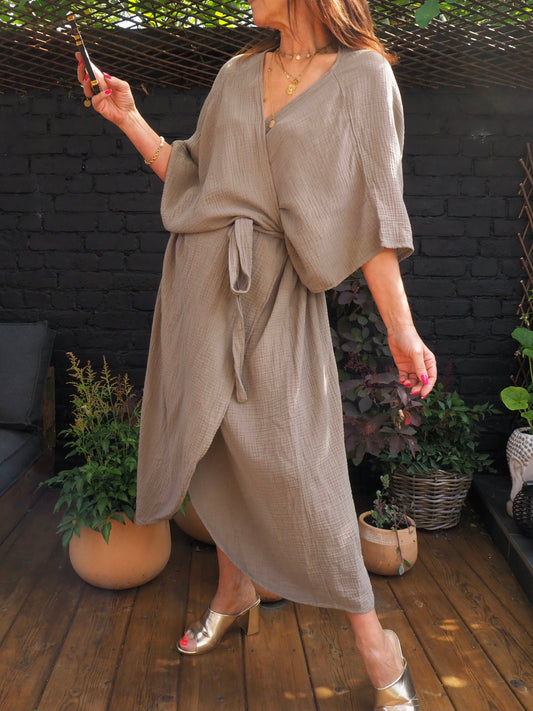Robe large en gaz de coton taupe, se noue de manière porte-feuille puis nouée avec une ceinture.  100% Coton. Taille unique du 36 au 42/44.